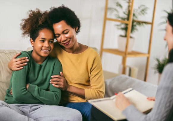 Mother and her teenager daughter talking with therapist. Family Therapy